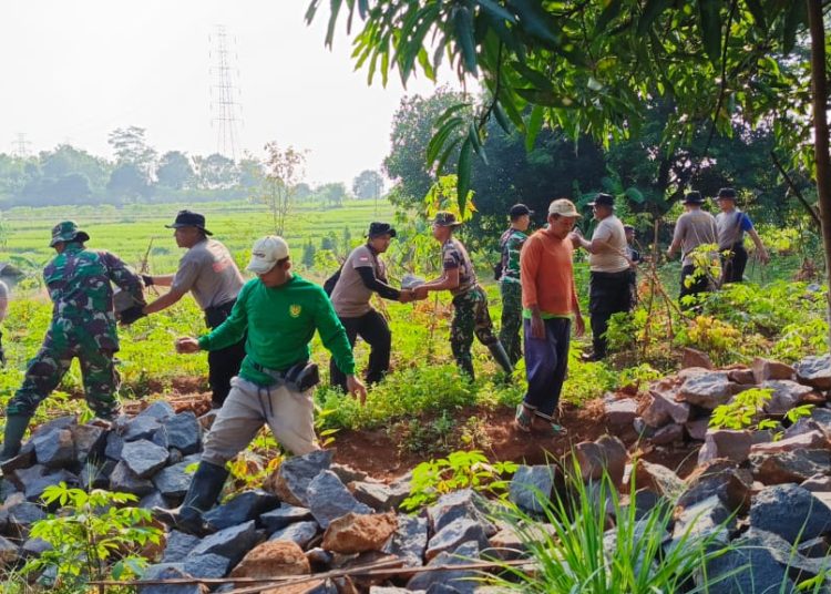 Personel gabungan dan warga saat gotong royong membuat akses jalan dalam TMMD ke-121 di Desa Kubang, Kecamatan Talun, Kabupaten Cirebon, Kamis (25/7/2024).